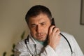 Portrait of absorbed doctor talking on his mobile phone