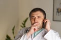 Portrait of absorbed doctor talking on his mobile phone