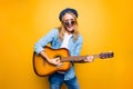 Portrait of active attractive young guitarist man playing on gui Royalty Free Stock Photo