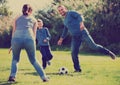 Portrait of active family playing soccer