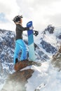 Portrait of active female snowboarder in funny hat standing on top of the mountain background Royalty Free Stock Photo