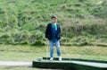 Portrait active kid playing mini golf in the park, Cute young boy doing outdoor activity playing crazy golf in the Spring field, Royalty Free Stock Photo