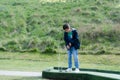 Portrait active kid playing mini golf in the park, Cute young boy doing outdoor activity playing crazy golf in the Spring field, Royalty Free Stock Photo