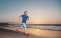 Portrait of active middle age man jogging running outside by sea. Royalty Free Stock Photo