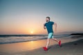 Portrait of active middle age man jogging running outside by sea. Royalty Free Stock Photo