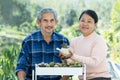 portrait active senior couple spend free time take care cactus plant together at home