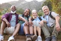 Portrait Of Active Senior Friends Sitting Taking A Break Hiking Through Countryside Together Royalty Free Stock Photo