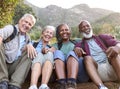 Portrait Of Active Senior Friends Sitting Taking A Break Hiking Through Countryside Together Royalty Free Stock Photo