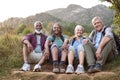 Portrait Of Active Senior Friends Sitting Taking A Break Hiking Through Countryside Together Royalty Free Stock Photo