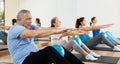 Senior man doing sit-ups with pilates ball at gym Royalty Free Stock Photo