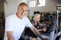 Portrait Of Active Senior Man Resting After Exercising On Cycling Machines In Gym Royalty Free Stock Photo