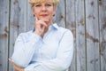 Portrait of an active senior woman looking at camera with a pens Royalty Free Stock Photo