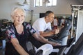 Portrait Of Active Senior Woman Resting After Exercising On Cycling Machines In Gym Royalty Free Stock Photo