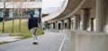 Portrait of active skater boy balancing on skateboard on urban background. Banner copy space. Focused skateboarder