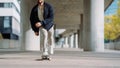 Portrait of active skater boy balancing on skateboard on urban background Focused skateboarder moving on skate board