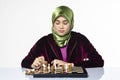 Active young woman playing chess over white background