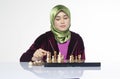 Active young woman playing chess over white background