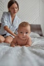 Portrait of adorable baby in bed lying on tummy Royalty Free Stock Photo