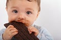 Portrait of an adorable baby eating chocolate Royalty Free Stock Photo