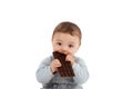 Portrait of an adorable baby eating a chocolate bar Royalty Free Stock Photo