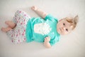 Portrait of adorable baby girl with blue eyes and cute hair looking at the camera calmly with curiosity