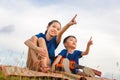 Portrait of adorable brother and sister playing outdoors. Happy kids boy and girl with guitar having fun outdoor Royalty Free Stock Photo