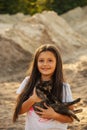 Portrait of adorable child with kitten. Baby girl holding hands a kitten in the light of sunset, pet, friend, lifestyle Royalty Free Stock Photo