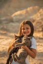 Portrait of adorable child with kitten. Baby girl holding hands a kitten in the light of sunset, pet, friend, lifestyle Royalty Free Stock Photo