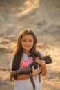 Portrait of adorable child with kitten. Baby girl holding hands a kitten in the light of sunset, pet, friend, lifestyle Royalty Free Stock Photo
