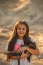 Portrait of adorable child with kitten. Baby girl holding hands a kitten in the light of sunset, pet, friend, lifestyle Royalty Free Stock Photo