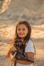 Portrait of adorable child with kitten. Baby girl holding hands a kitten in the light of sunset, pet, friend, lifestyle Royalty Free Stock Photo