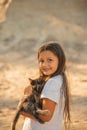 Portrait of adorable child with kitten. Baby girl holding hands a kitten in the light of sunset, pet, friend, lifestyle Royalty Free Stock Photo