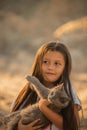 Portrait of adorable child with kitten. Baby girl holding hands a kitten in the light of sunset, pet, friend, lifestyle Royalty Free Stock Photo