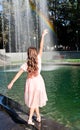 Portrait of adorable dancing little girl child in the park on summer day