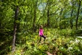 Portrait of adorable hiking little girl on spring day in forest