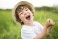 Portrait of adorable kid boy with hat standing on a summer meadow Royalty Free Stock Photo