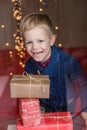 Portrait of adorable kid with gift boxes. Christmas. Birthday