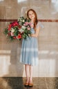 Portrait of adorable kid girl holding big flower bouquet Royalty Free Stock Photo