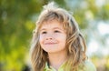 Portrait of adorable little boy on green background park in nature. Wow look. Portrait of amazed cute little boy with