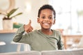 Whos the best boy Me. Portrait of an adorable little boy showing thumbs up on the sofa at home.