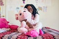 I cant sleep without my best friend. Portrait of an adorable little girl holding a plush toy while sitting on her bed in Royalty Free Stock Photo