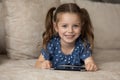 Portrait of adorable little girl with smartphone. Royalty Free Stock Photo