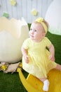 Pensive little girl in yellow dress with decoration in her hair