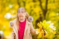 Portrait of adorable little girl with yellow leaves bouquet in fall Royalty Free Stock Photo