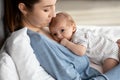 Portrait Of Adorable Little Newborn Baby In Bodysuit Resting On Mother's Chest Royalty Free Stock Photo