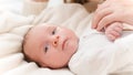 Portrait of adorable newborn baby and happy smiling mother. Mom tickling and playing with child in crib. Concept of Royalty Free Stock Photo