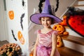 Adorable girl posing in pink dress and witch hat Royalty Free Stock Photo