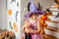 Adorable girl posing in pink dress and witch hat Royalty Free Stock Photo