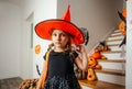 Adorable girl posing in pink dress and witch hat Royalty Free Stock Photo