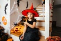 Adorable girl posing in pink dress and witch hat Royalty Free Stock Photo